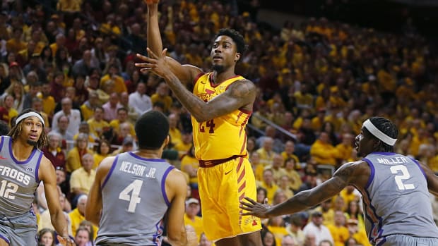 Iowa State Cyclones forward Hason Ward (24) passes the ball between TCU Horned Frogs guard Jameer Nelson Jr. (4) and forward Emanuel Miller (2) during the first half in the Big-12 conference showdown of a NCAA college basketball at Hilton Coliseum on Saturday, Feb. 10, 2024, in Ames, Iowa.